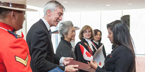 President David Agnew and Rt. Honourable Adrienne Clarkson congratulating new Canadians